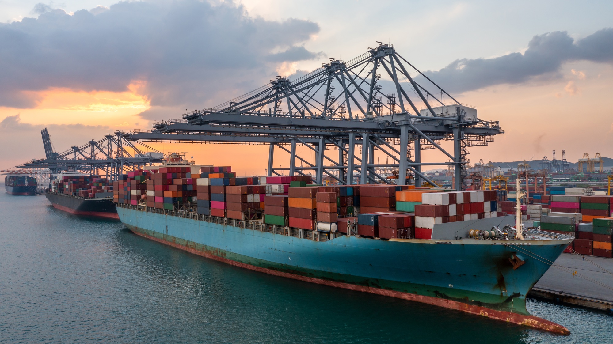 Container cargo ship at commercial terminal seaport, Global business logistic import export.