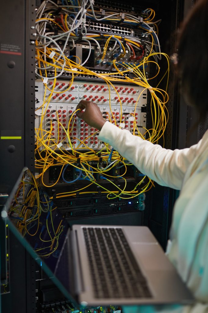 Female Network Technician Connecting Cables Close Up